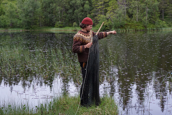 Sander Vandenborre setting a fish net in a lake